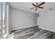 Bright bedroom with large window and wood-look flooring at 3475 Oak Valley Ne Rd # 910, Atlanta, GA 30326