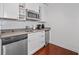 Compact kitchenette with stainless steel appliances, white cabinetry, and a modern countertop at 3475 Oak Valley Ne Rd # 910, Atlanta, GA 30326