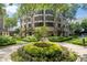 Lush landscaping and trees surrounding The Oaks Buckhead with views of the building at 3475 Oak Valley Ne Rd # 910, Atlanta, GA 30326