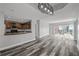 Open-concept living room showcases modern lighting fixture, hardwood floors, and a kitchen pass-through at 3475 Oak Valley Ne Rd # 910, Atlanta, GA 30326