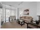Cozy living room with a comfortable couch, balcony access, and stylish decor at 3475 Oak Valley Ne Rd # 910, Atlanta, GA 30326