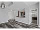 Open concept kitchen and living room showcasing hardwood floors, with a view of the bathroom at 3475 Oak Valley Ne Rd # 910, Atlanta, GA 30326