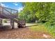 Backyard with deck, stairs and wooded surroundings at 3999 Phils Ct, Tucker, GA 30084