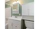 Bathroom features a white vanity, updated fixtures, and storage space above the toilet at 3999 Phils Ct, Tucker, GA 30084