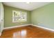 Bedroom featuring hardwood flooring, a window, and light green walls at 3999 Phils Ct, Tucker, GA 30084
