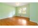 Bright bedroom with hardwood floors, a ceiling fan, and a large window at 3999 Phils Ct, Tucker, GA 30084