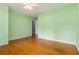 Green bedroom with hardwood floors and white trim at 3999 Phils Ct, Tucker, GA 30084