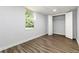 Bedroom showcasing wood-look floors, a window letting in natural light, and closet with double doors at 3999 Phils Ct, Tucker, GA 30084