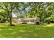 Charming home nestled among mature trees, featuring a well-kept lawn and inviting porch at 3999 Phils Ct, Tucker, GA 30084