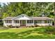 Charming single-story home with a well-manicured lawn and inviting front porch at 3999 Phils Ct, Tucker, GA 30084