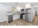 Kitchen featuring stainless steel appliances, white cabinets, and wood-look floors at 3999 Phils Ct, Tucker, GA 30084