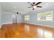 Well-lit living room with hardwood floors, two ceiling fans and natural light from windows at 3999 Phils Ct, Tucker, GA 30084