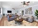 Cozy living room with hardwood floors, recessed lighting, ceiling fans, and comfortable seating arrangements at 3999 Phils Ct, Tucker, GA 30084