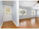 Bright living room with hardwood floors, neutral walls, and a front door with leaded glass at 3999 Phils Ct, Tucker, GA 30084