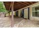 Covered patio area with access to basement entrance with a chair at 3999 Phils Ct, Tucker, GA 30084