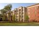 Multi-story apartment building with manicured landscaping and mature trees at 870 Mayson Turner Nw Rd # 1238, Atlanta, GA 30314