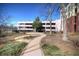 Exterior of the building with landscaped grounds and sidewalk leading to parking area at 870 Mayson Turner Nw Rd # 1238, Atlanta, GA 30314