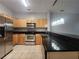 Kitchen with stainless steel appliances, black countertops, and pendant lighting at 870 Mayson Turner Nw Rd # 1238, Atlanta, GA 30314