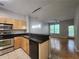 Modern kitchen open to living area with stainless steel appliances and black countertops at 870 Mayson Turner Nw Rd # 1238, Atlanta, GA 30314