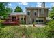 The backyard features a deck and patio, surrounded by green foliage at 1115 Manor Nw Way, Kennesaw, GA 30144