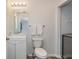 Bright bathroom features a white vanity, toilet, and neutral walls at 1115 Manor Nw Way, Kennesaw, GA 30144
