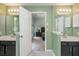 Bathroom with dual vanities and a view into the bedroom through an open door at 1115 Manor Nw Way, Kennesaw, GA 30144
