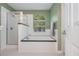 Bathroom with a soaking tub, glass shower, and classic black and white tiled flooring at 1115 Manor Nw Way, Kennesaw, GA 30144