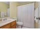 Compact bathroom showcasing a sink, toilet, and shower with a patterned curtain at 1115 Manor Nw Way, Kennesaw, GA 30144