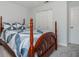 Bedroom with a four-poster bed, light walls and plush carpeting, showcasing a closet and door at 1115 Manor Nw Way, Kennesaw, GA 30144