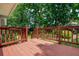 Open wooden deck with railings overlooks a green yard and mature trees, ideal for outdoor enjoyment at 1115 Manor Nw Way, Kennesaw, GA 30144