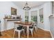 Bright dining room featuring hardwood floors, a rustic wood table with seating for six, and natural light from large windows at 1115 Manor Nw Way, Kennesaw, GA 30144