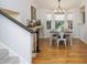 Bright dining area features hardwood floors, an elegant chandelier, and natural light from the surrounding windows at 1115 Manor Nw Way, Kennesaw, GA 30144