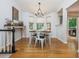 The dining room offers a wooden table set, stylish lighting, and a view to the backyard at 1115 Manor Nw Way, Kennesaw, GA 30144