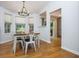 Bright dining area features hardwood floors, modern lighting, and a sliding glass door to the backyard at 1115 Manor Nw Way, Kennesaw, GA 30144