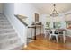 Sun-filled dining area with hardwood floors, a modern chandelier, and a charming bar table with drinks at 1115 Manor Nw Way, Kennesaw, GA 30144