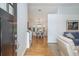 Inviting entryway with hardwood floors, leading into a dining area and a glimpse of the living room with a comfortable sofa at 1115 Manor Nw Way, Kennesaw, GA 30144