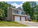 Two-story home features a two-car garage, well-maintained lawn, and charming curb appeal at 1115 Manor Nw Way, Kennesaw, GA 30144