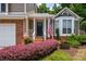 Charming home with a welcoming front porch, brick accents, and colorful landscaping at 1115 Manor Nw Way, Kennesaw, GA 30144