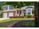 Beautiful home boasts a manicured front yard with colorful flowers and lush green grass at 1115 Manor Nw Way, Kennesaw, GA 30144