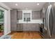 Modern kitchen equipped with stainless steel appliances and sleek gray cabinets for a stylish and functional space at 1115 Manor Nw Way, Kennesaw, GA 30144