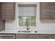 Stylish kitchen with sleek gray cabinets, stainless steel appliances, and a window view to the backyard at 1115 Manor Nw Way, Kennesaw, GA 30144