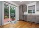 Modern kitchen features stainless steel appliances, sleek gray cabinets, and a sliding door to the backyard at 1115 Manor Nw Way, Kennesaw, GA 30144