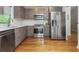 Modern kitchen with stainless steel appliances, sleek cabinetry, subway tile backsplash, and beautiful hardwood floors at 1115 Manor Nw Way, Kennesaw, GA 30144