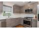 Modern kitchen features stainless steel appliances, sleek gray cabinets, and a white subway tile backsplash at 1115 Manor Nw Way, Kennesaw, GA 30144