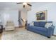 Cozy living room featuring a sofa, a recliner, stairs and art, offering comfortable space at 1115 Manor Nw Way, Kennesaw, GA 30144