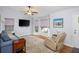 Cozy living room featuring a comfortable sofa, a recliner, and a large bay window offering abundant natural light at 1115 Manor Nw Way, Kennesaw, GA 30144