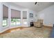 Bright living room featuring hardwood floors, a recliner, and a large bay window offering abundant natural light at 1115 Manor Nw Way, Kennesaw, GA 30144