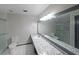 Bathroom showcasing a large vanity mirror, granite countertop, and tiled floors at 3038 Skidaway Ct, Stone Mountain, GA 30087