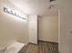 Bathroom features modern lighting, vinyl floors, sleek vanity, and a neutral color scheme at 3038 Skidaway Ct, Stone Mountain, GA 30087