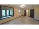 Bedroom with wood-look floors, overhead lighting and view of green space from two windows at 3038 Skidaway Ct, Stone Mountain, GA 30087